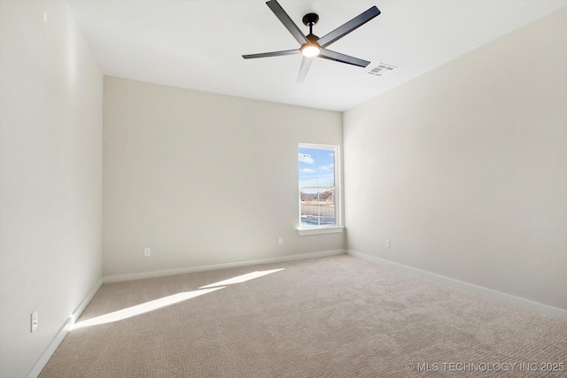 empty room with ceiling fan and light colored carpet
