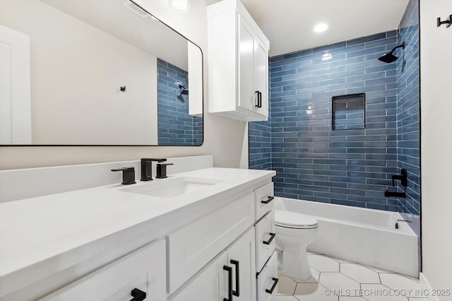 full bathroom with tile patterned floors, vanity, toilet, and tiled shower / bath