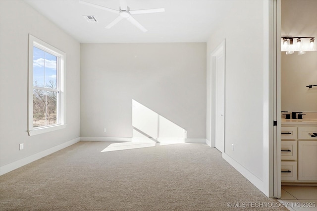 carpeted spare room featuring ceiling fan