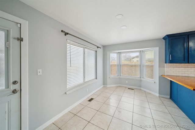 unfurnished dining area with light tile patterned floors