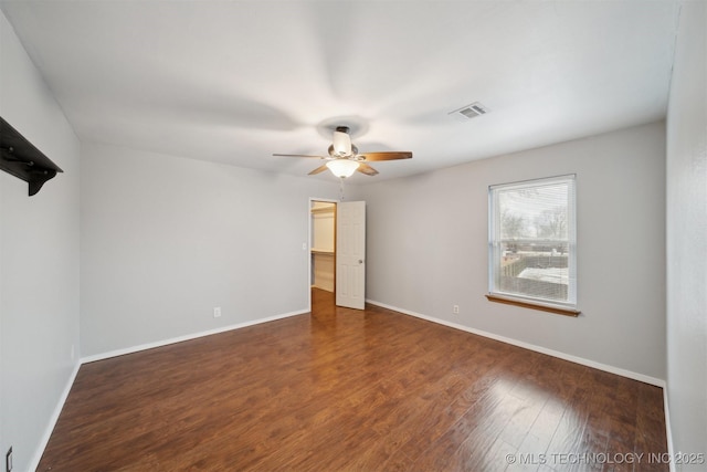 spare room featuring dark hardwood / wood-style floors and ceiling fan