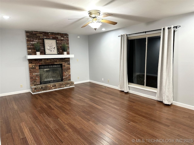 unfurnished living room featuring hardwood / wood-style flooring, a fireplace, and ceiling fan