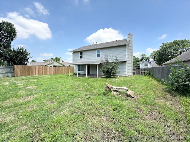 1504 N 26th St, Broken Arrow, OK 74014 - rear view of house with a fenced backyard, a chimney, and a patio