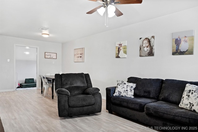 living room featuring ceiling fan and wood-type flooring