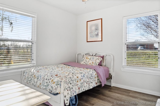 bedroom with dark hardwood / wood-style flooring