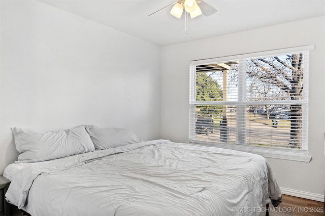 bedroom with ceiling fan and wood-type flooring