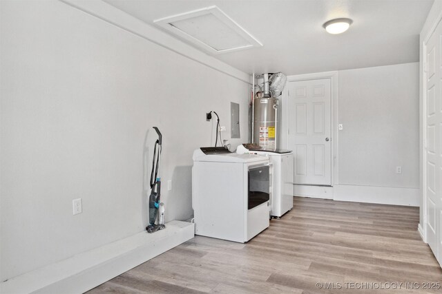 laundry area with washing machine and clothes dryer, electric panel, water heater, and light wood-type flooring