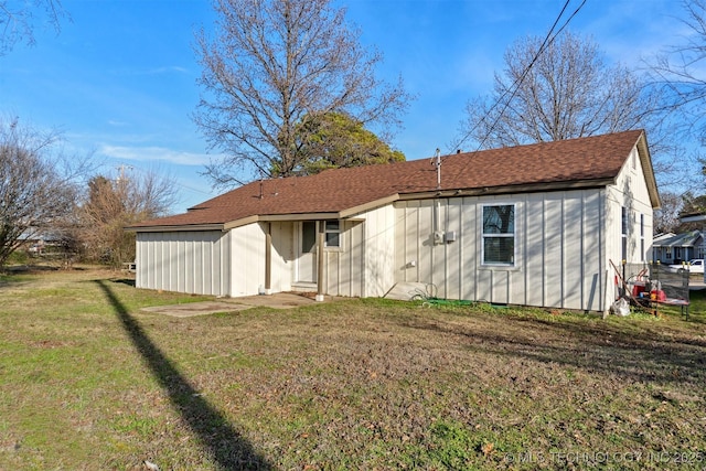 back of property featuring a yard