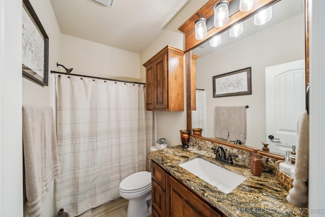 full bath featuring wood finished floors, curtained shower, vanity, and toilet