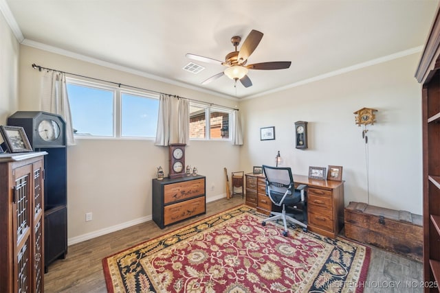 office space featuring dark hardwood / wood-style flooring, ceiling fan, and ornamental molding