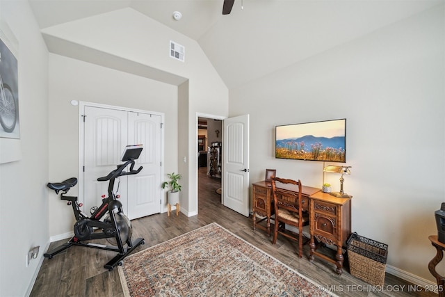 office area featuring visible vents, a ceiling fan, wood finished floors, high vaulted ceiling, and baseboards