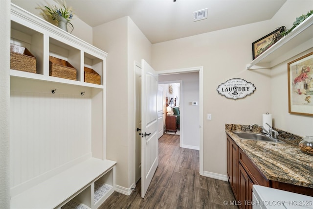 mudroom with baseboards, visible vents, dark wood finished floors, and a sink