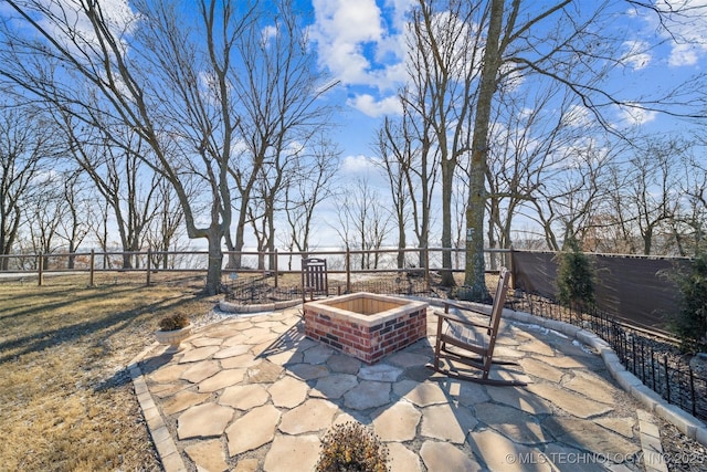 view of patio with a fenced backyard and a fire pit