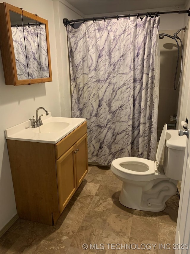 bathroom featuring vanity, curtained shower, and toilet