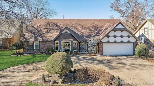 tudor house with a front yard, brick siding, concrete driveway, and an attached garage