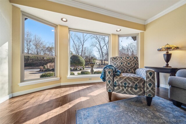 living area with recessed lighting, baseboards, wood-type flooring, and ornamental molding