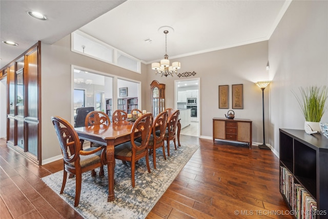 dining area featuring a chandelier, dark wood-style floors, crown molding, and baseboards