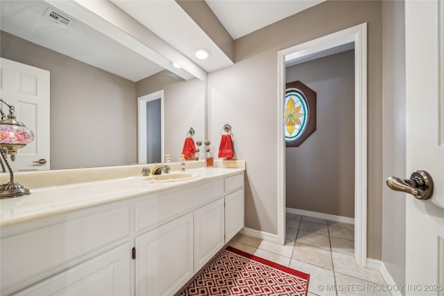 bathroom featuring tile patterned floors, visible vents, vanity, and baseboards