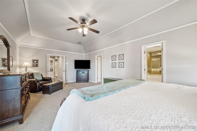 bedroom featuring visible vents, light colored carpet, lofted ceiling, ornamental molding, and ensuite bathroom