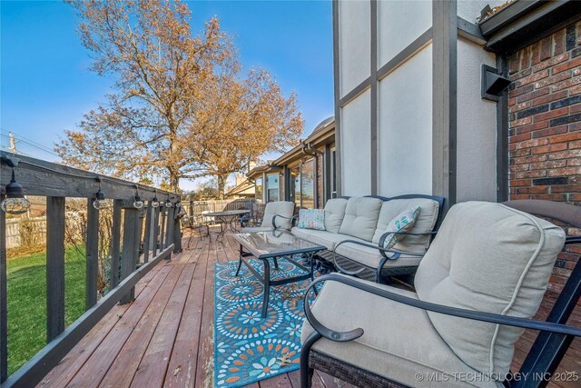 deck with an outdoor living space, outdoor dining area, and fence