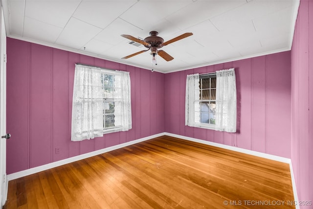 spare room with ceiling fan, ornamental molding, and wood-type flooring