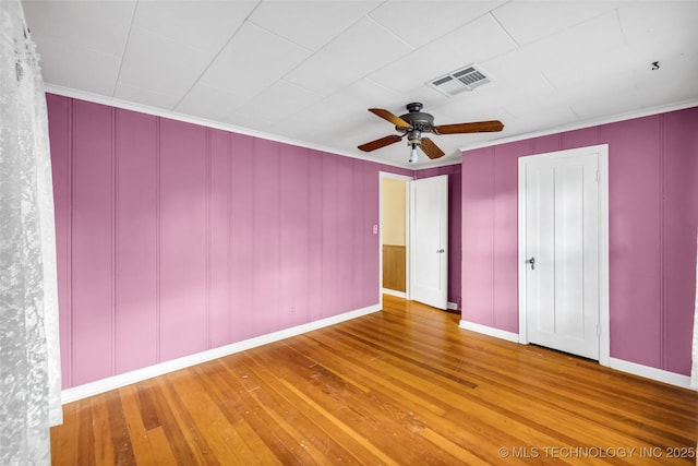 unfurnished bedroom featuring ceiling fan, hardwood / wood-style flooring, and ornamental molding