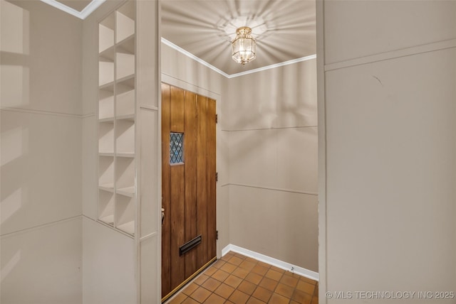 interior space featuring ornamental molding and built in shelves