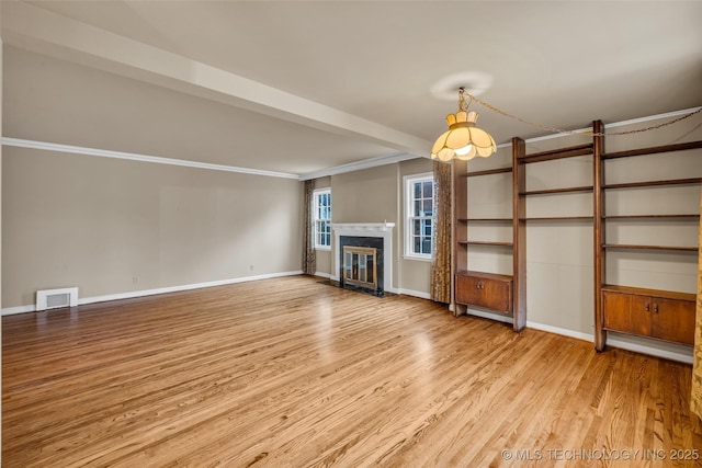 unfurnished living room featuring light hardwood / wood-style floors, ornamental molding, and beamed ceiling