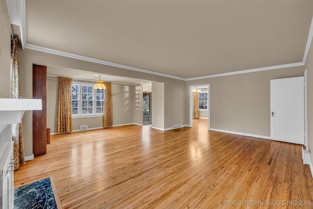 unfurnished living room featuring a chandelier, crown molding, a fireplace, and light hardwood / wood-style flooring