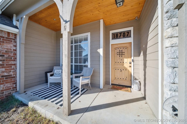 doorway to property featuring brick siding