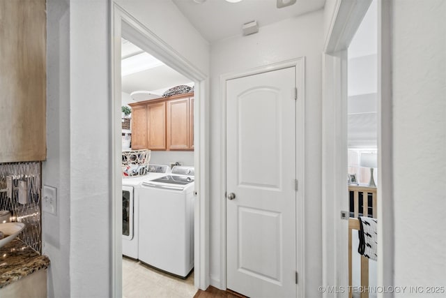 laundry room with washer and dryer and cabinet space