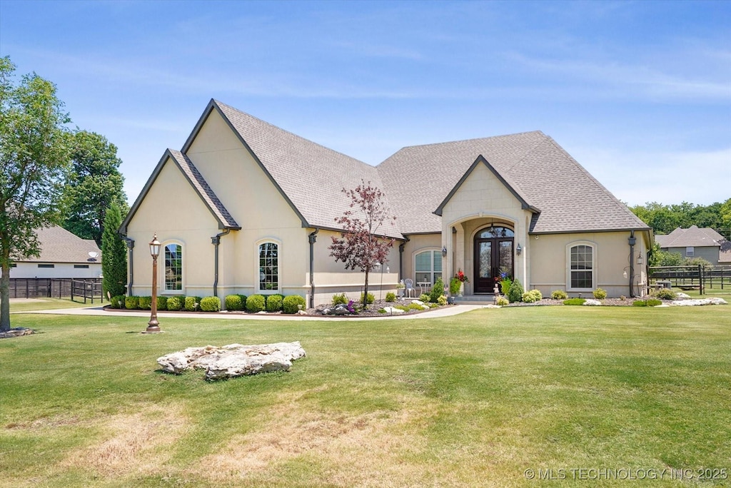 french country style house with a front lawn and french doors