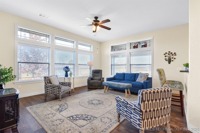 living room with dark hardwood / wood-style flooring and ceiling fan