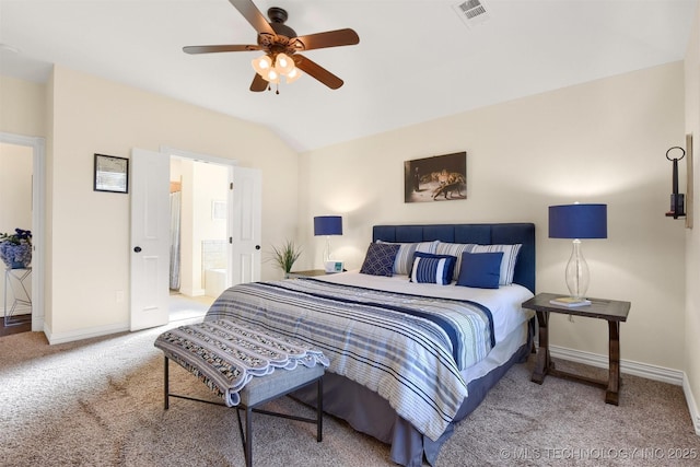 bedroom featuring ceiling fan, lofted ceiling, carpet floors, and ensuite bath