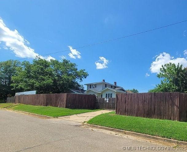 exterior space featuring a fenced front yard and a front lawn