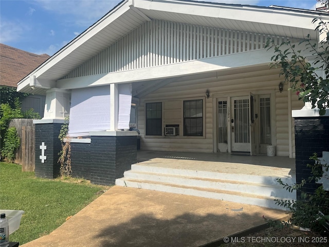 view of exterior entry featuring a porch