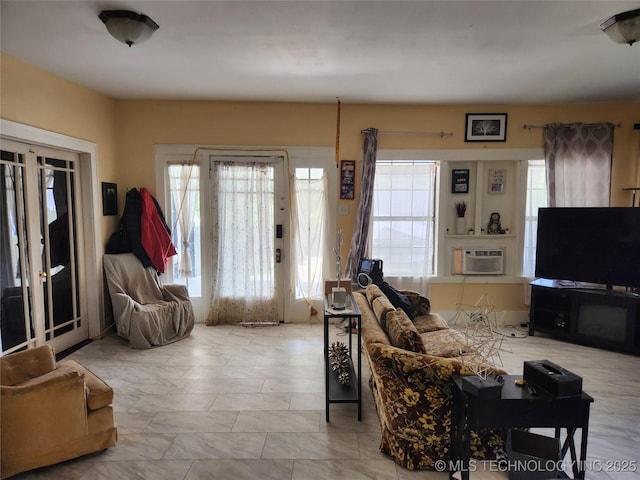 living area with an AC wall unit