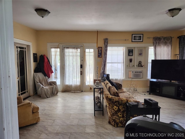 living room featuring plenty of natural light and a wall mounted AC