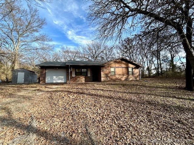 ranch-style house with a garage and a shed