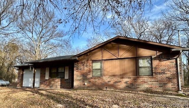 view of side of home with brick siding