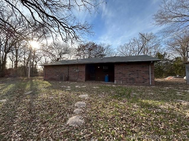 rear view of house with brick siding