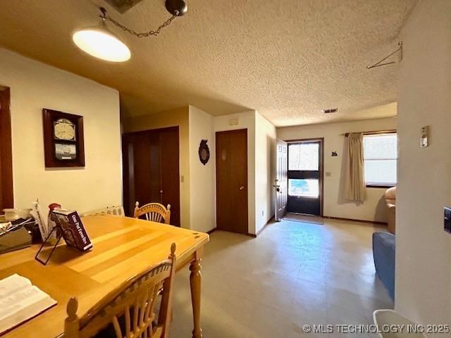 dining room featuring a textured ceiling