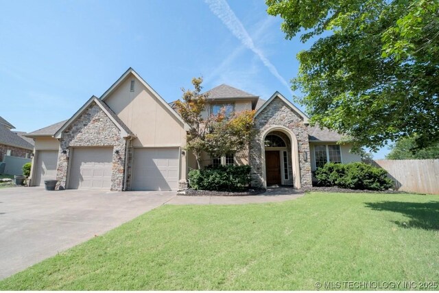 view of front of house featuring a front yard and a garage