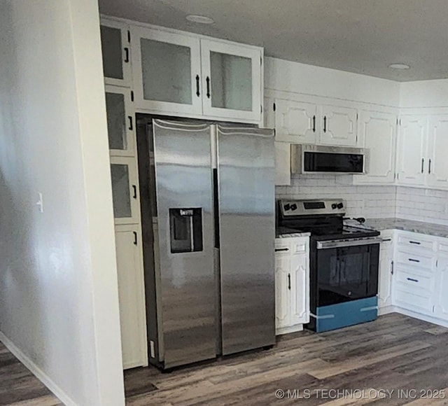 kitchen with white cabinetry, dark hardwood / wood-style flooring, and appliances with stainless steel finishes