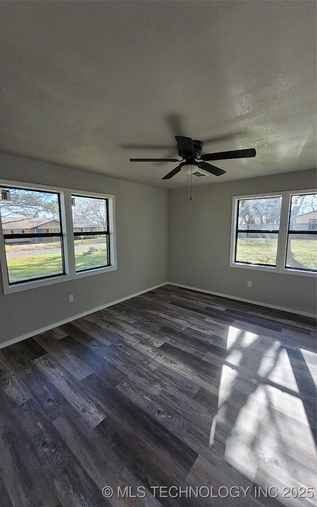 unfurnished room featuring a textured ceiling, dark hardwood / wood-style floors, and ceiling fan