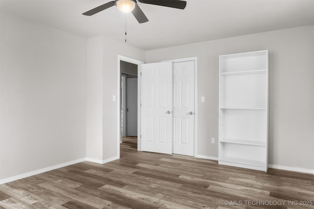 unfurnished bedroom featuring ceiling fan, wood finished floors, and baseboards