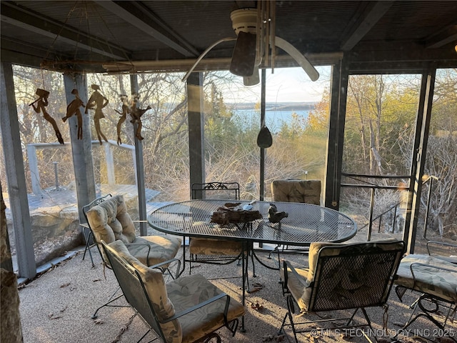 sunroom / solarium with a water view