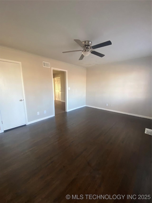 unfurnished room featuring dark hardwood / wood-style floors and ceiling fan