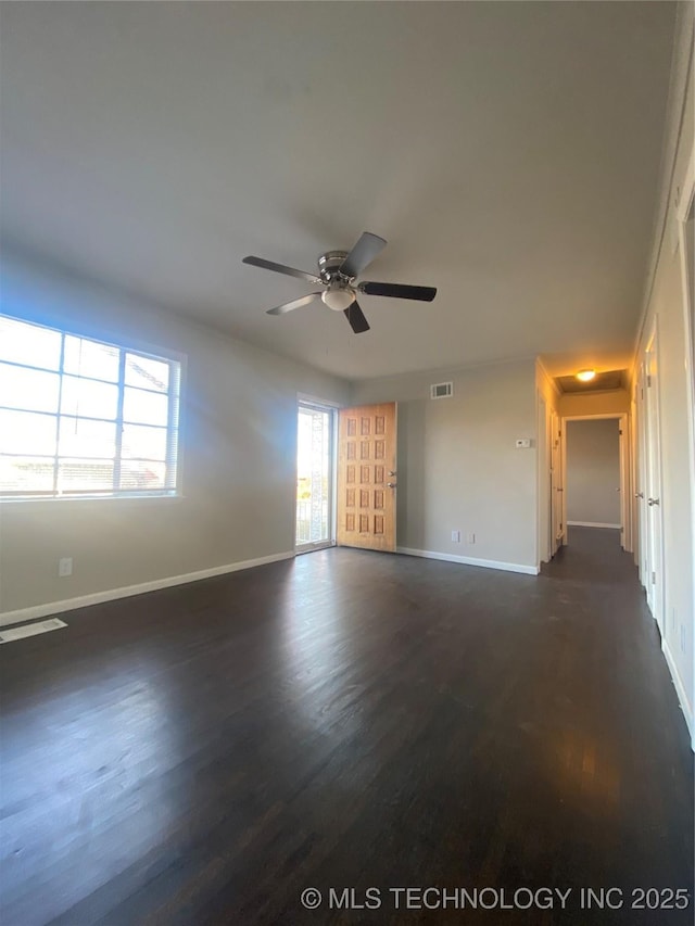 empty room featuring ceiling fan and dark hardwood / wood-style floors