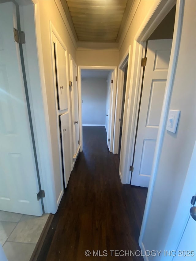 hall featuring dark hardwood / wood-style floors and wooden ceiling